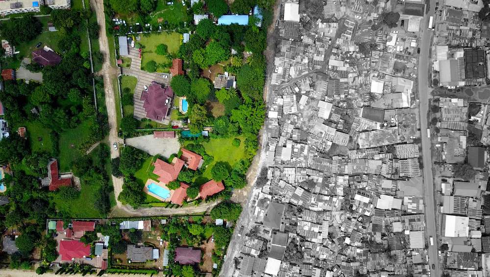 Masaki, one of Dar es Salaam&#39;s wealthiest suburbs, is a mix of precisely organised streets, neatly cut trees and swimming pools
